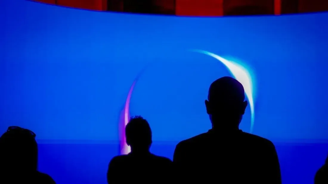 A person standing next to a group of white machines

AI-generated content may be incorrect.
